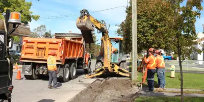 Road workers and equipment working on a road