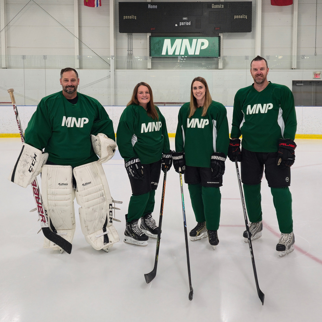 People dressed in green hockey attire at MNP rink at INVISTA Centre.