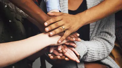 Diverse hands over top of each other