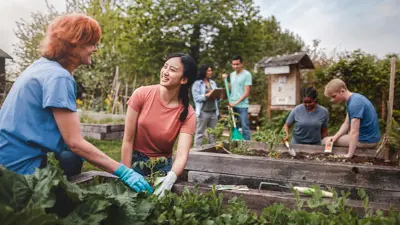 Community of people tending to a garden outside