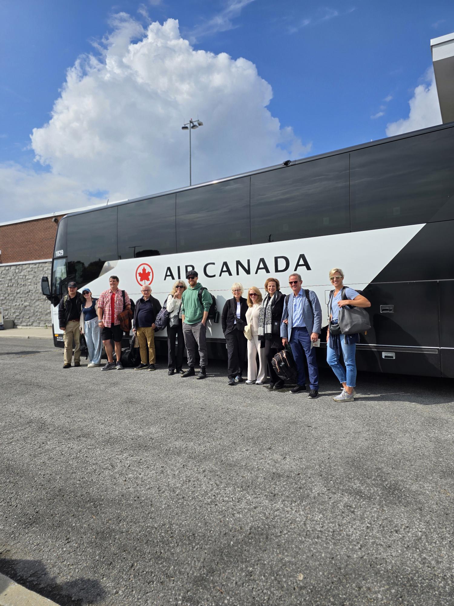 People lined up in front of Air Canada bus