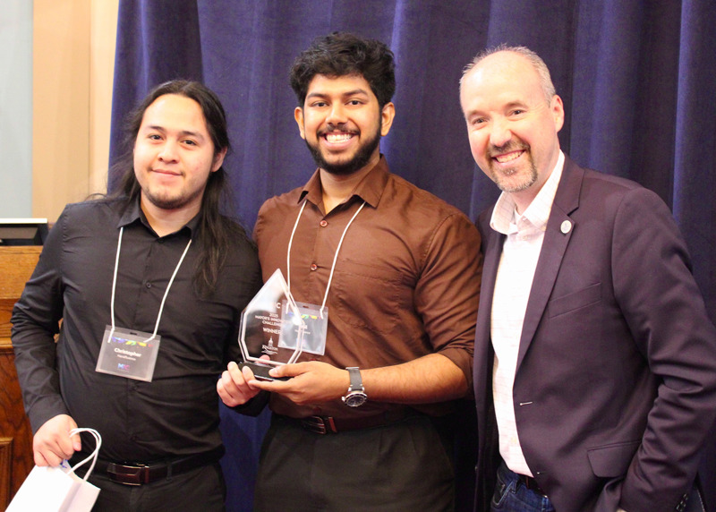 Two members of the Handlfluence team posing next to Mayor Bryan Paterson