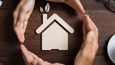 Hand surrounding a house icon
